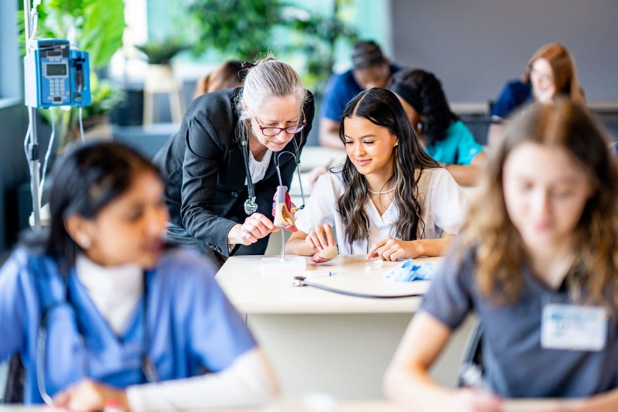 A classroom scene featuring nurses actively participating in a training session.