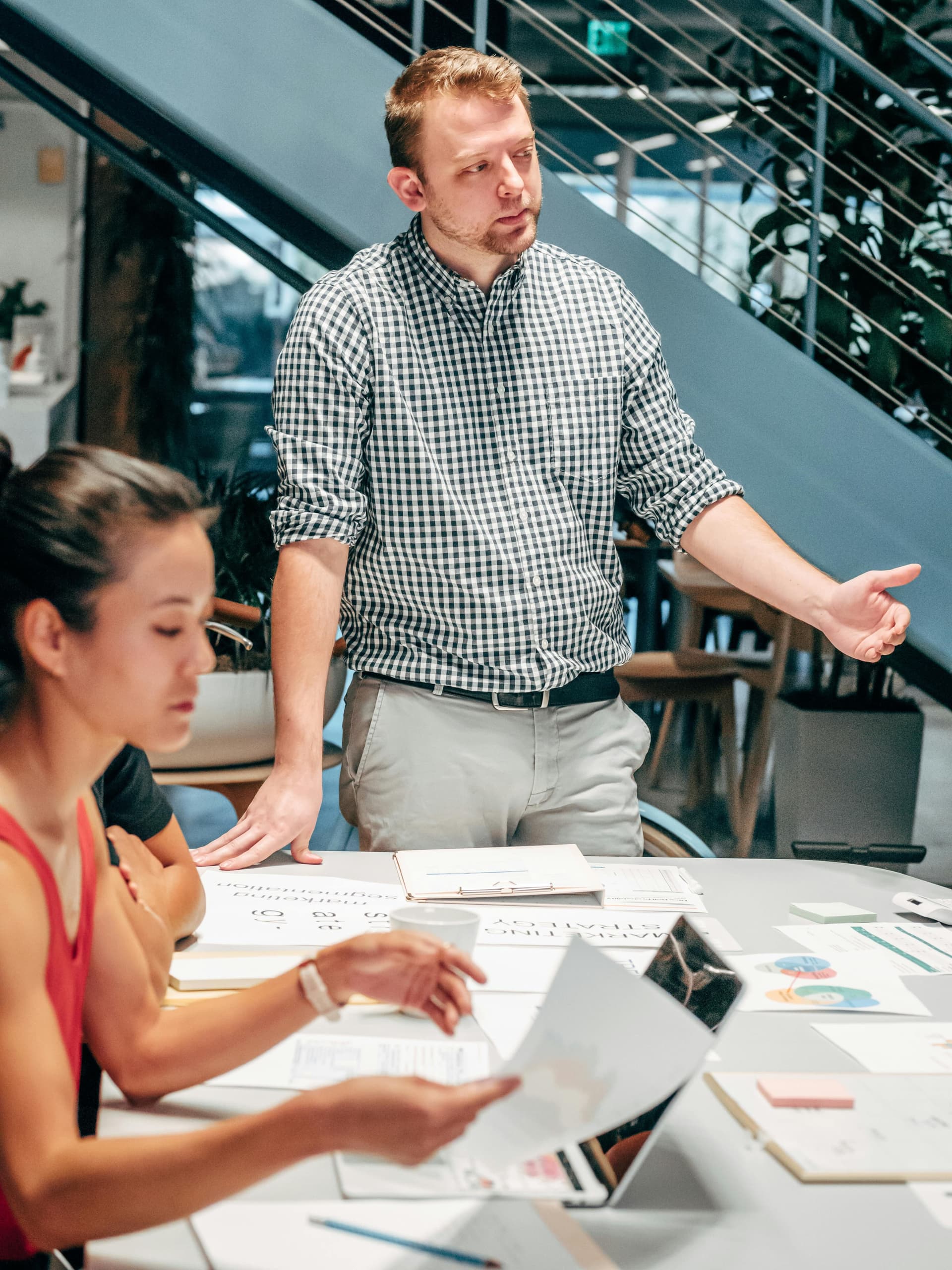People having a discussion around a table with documents.
